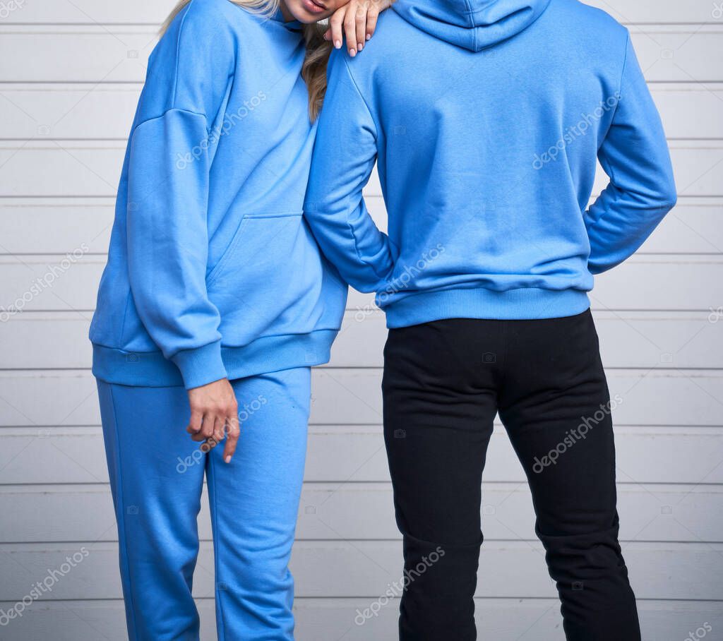 Pair of woman and man wear a no logo hoodie. sweatshirt design template. copy space street wear clothing