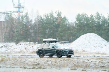 Modern arabayla karla kaplı bir yol.