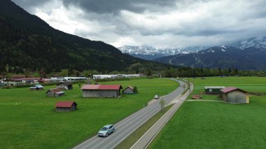 Dramatik bulutlu dağların altındaki kırsal kasaba