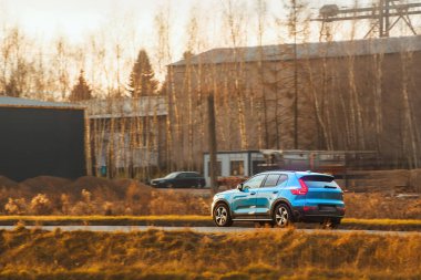 Kırsal yolda orman manzaralı bir araba.