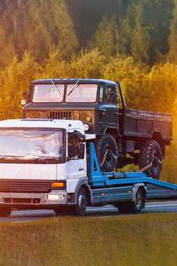 Düz yataklı taşıyıcıda klasik askeri kamyon.