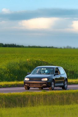Front view of hatchback on summer drive