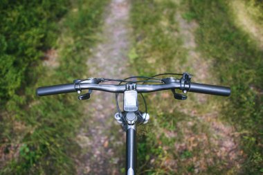 Dağ bisikletçisi orman arazisinde geziniyor.