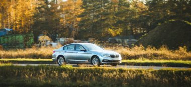 Araba çimenli tepelerden geçiyor.