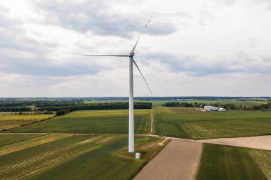Landscape with large white wind turbine