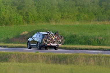 Rear bike rack holding bicycles on countryside road