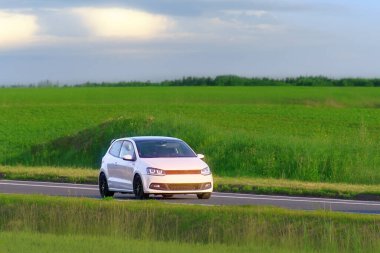 Front view of hatchback on summer drive