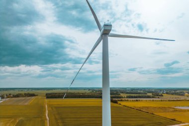 Landscape with large white wind turbine