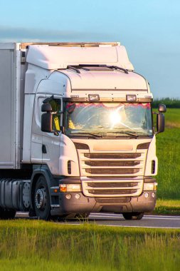 White semi truck isolated on summer roadway