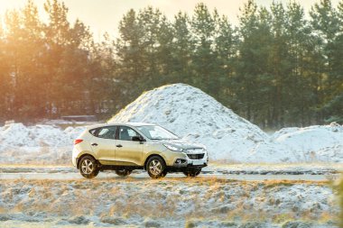 Automobile on road by rural hillside