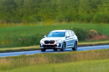Modern SUV in motion through countryside area