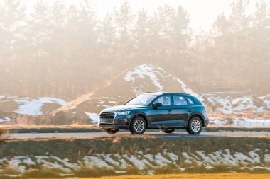 Stylish SUV cruising near green field