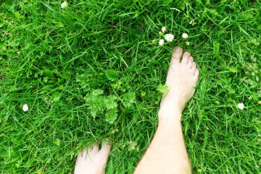 Yeşil bahçede çıplak ayaklı bir kadın.