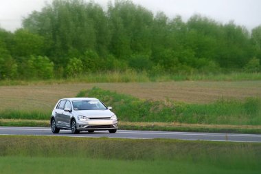 Front view of hatchback on summer drive