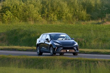 Huzurlu bir köy yolunda elektrikli SUV taşımacılığı