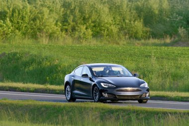 Clean energy vehicle moving through scenic countryside