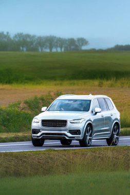 Fast SUV driving along quiet country road