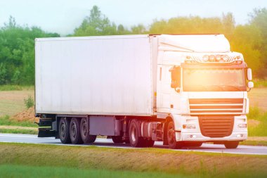 White semi truck isolated on summer roadway