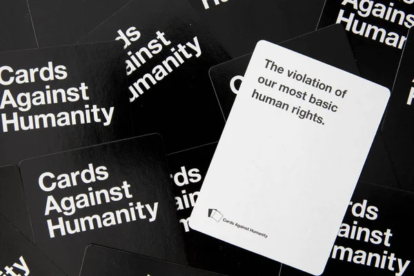 Adult party game cards against humanity scattered white and black cards referencing human rights
