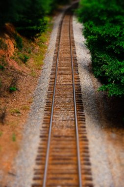 Railroad tracks with tilt shift lens effect clipart