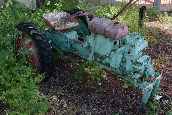 An old tractor skeleton with peeling paint in different colors many layers — Stock Photo, Image