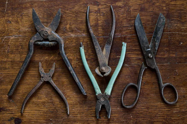 knoling with old and rusty tools on a vintage table made of lacquered wood view from the top