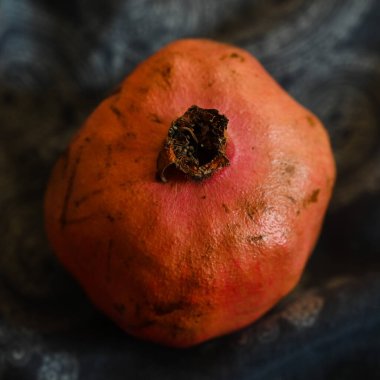 Ahşap setin sehpasında koca bir nar yatıyor.