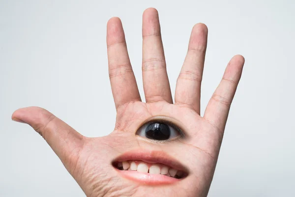 Una mano tiene ojo con sonriente — Foto de Stock