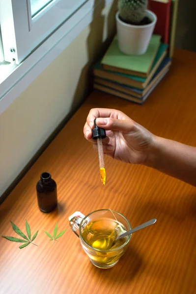 Person Pouring Cbd Oil Hot Drink Table Marijuana Leaves Using — Stock Photo, Image