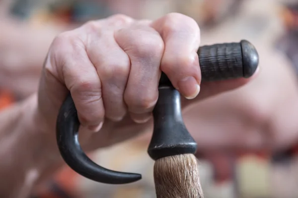 Hand of old person on cane — Stock Photo, Image