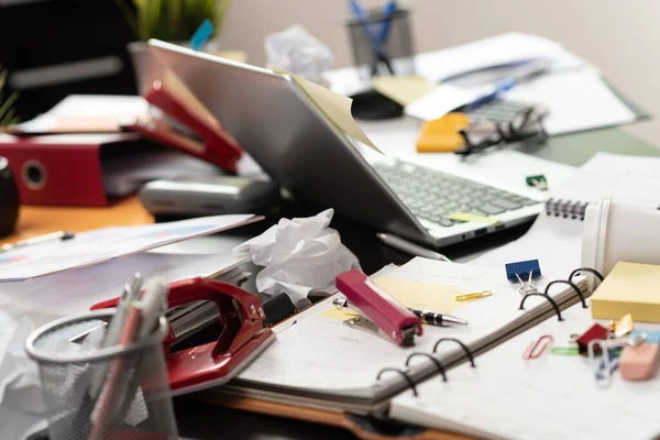 Messy and cluttered office desk