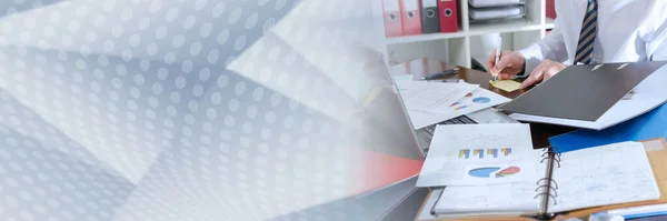 Businessman working at an untidy and cluttered desk; panoramic banner