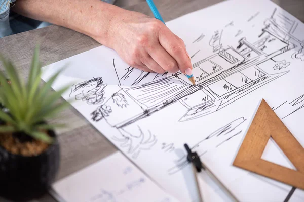 Female architect working on sketch of new construction project