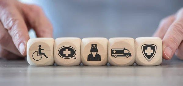 Concept of disability with icons on wooden cubes