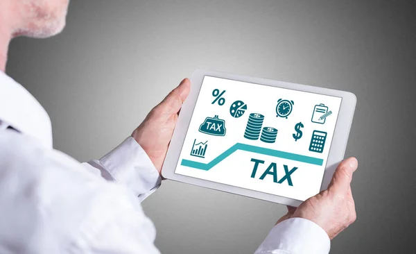 Man Holding Tablet Showing Tax Concept — Stock Photo, Image