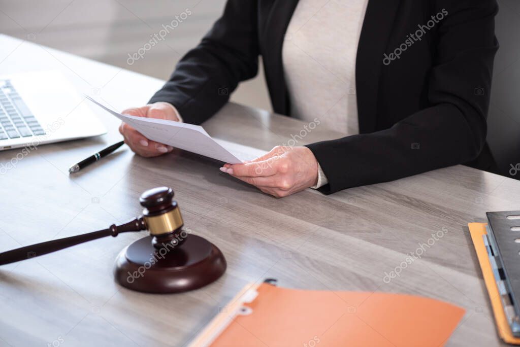 Female lawyer working on document. Legal, advice and justice concept