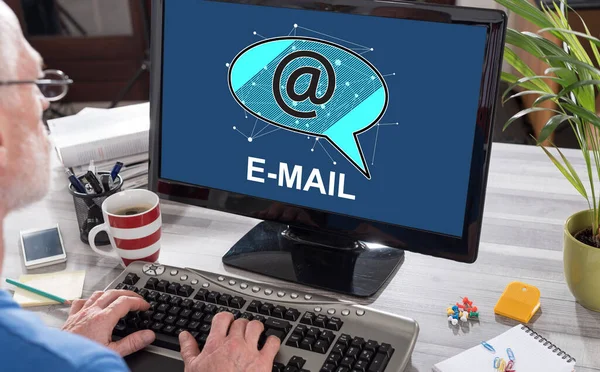 Man using a computer with email concept on the screen