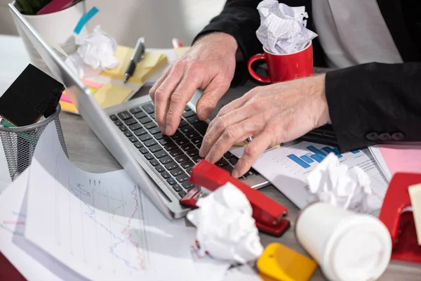 Businessman working on a cluttered and messy desk