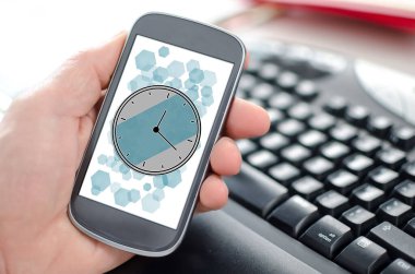 Zaman yönetimi kavramını gösteren bir akıllı telefonu el ele tutuşmak