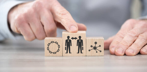 Wooden blocks with symbol of business relationship concept