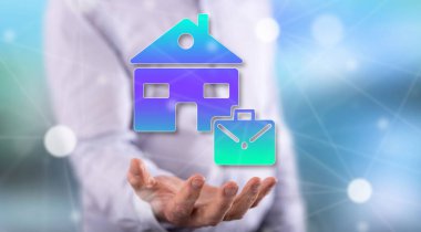 Ev konseptinden, arka plandaki bir adamın elinin üstünde çalışmak.