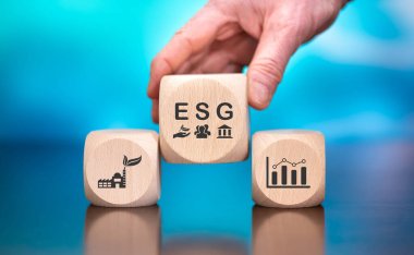 Wooden blocks with symbol of esg concept on blue background clipart