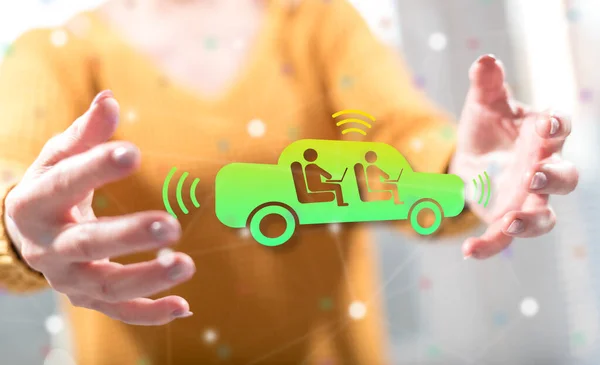 Autonomous vehicle concept between hands of a woman in background