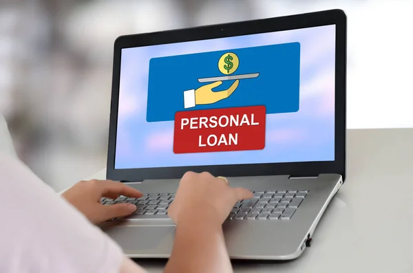 Woman using a laptop with personal loan concept on the screen
