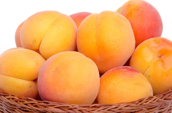 Fresh tasty apricots in a basket — Stock Photo, Image