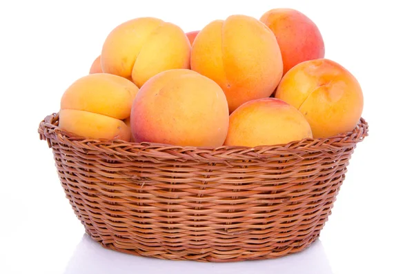 Fresh tasty apricots in a basket — Stock Photo, Image