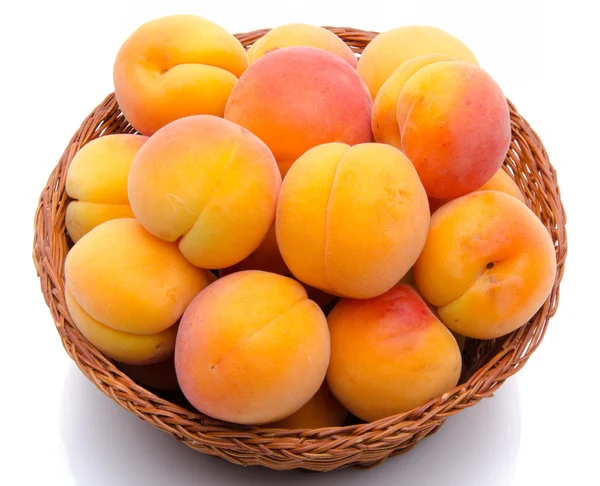 Fresh tasty apricots in a basket — Stock Photo, Image