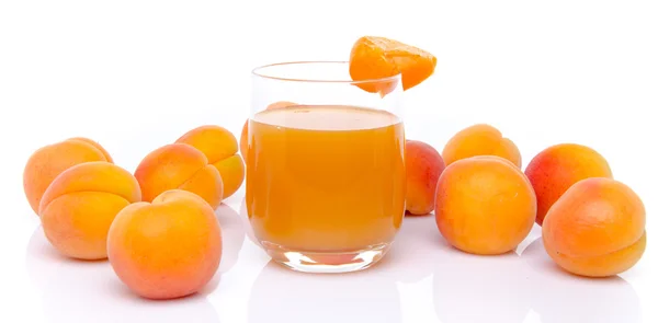 Glass of apricot juice surrounded with apricots — Stock Photo, Image