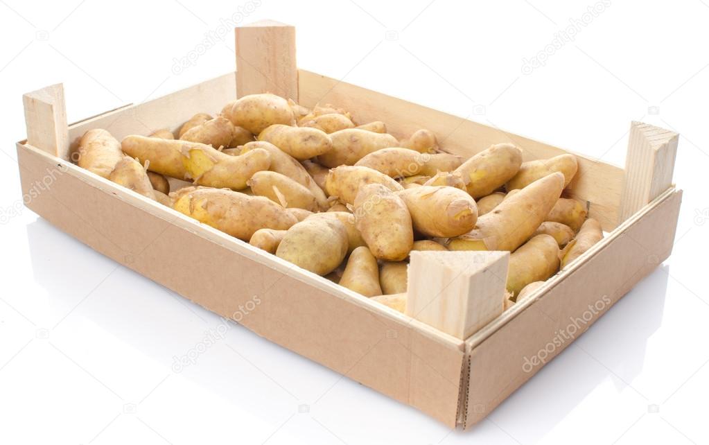 New rattes potatoes in a wooden crate
