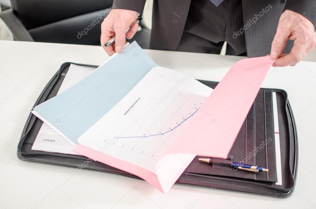 Businessman opening a folder